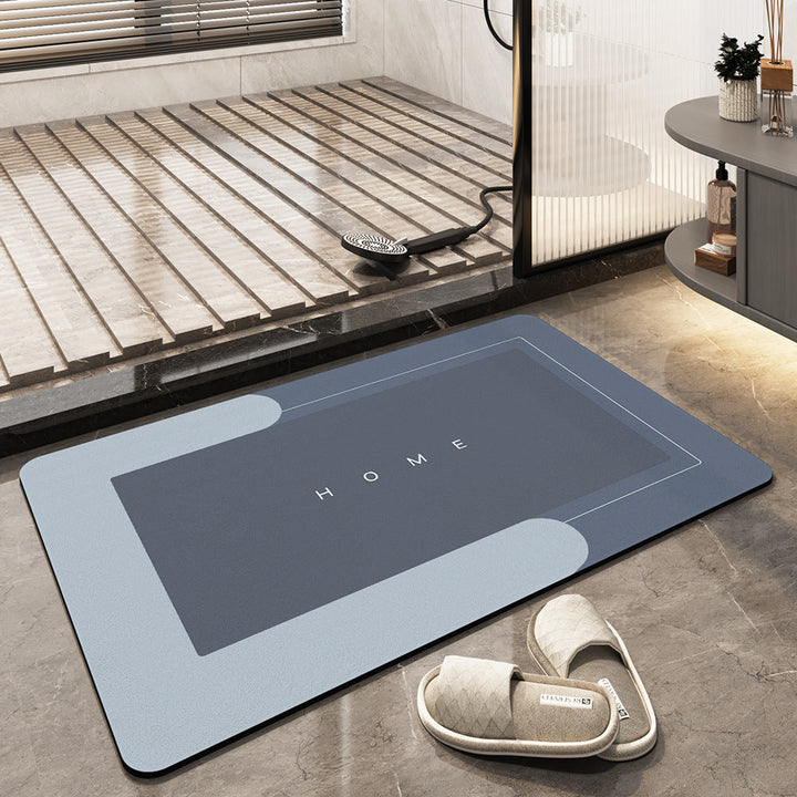 Tappeto da bagno antiscivolo grigio con scritta "HOME", design moderno, adatto per doccia, pavimento in marmo, include pantofole beige.