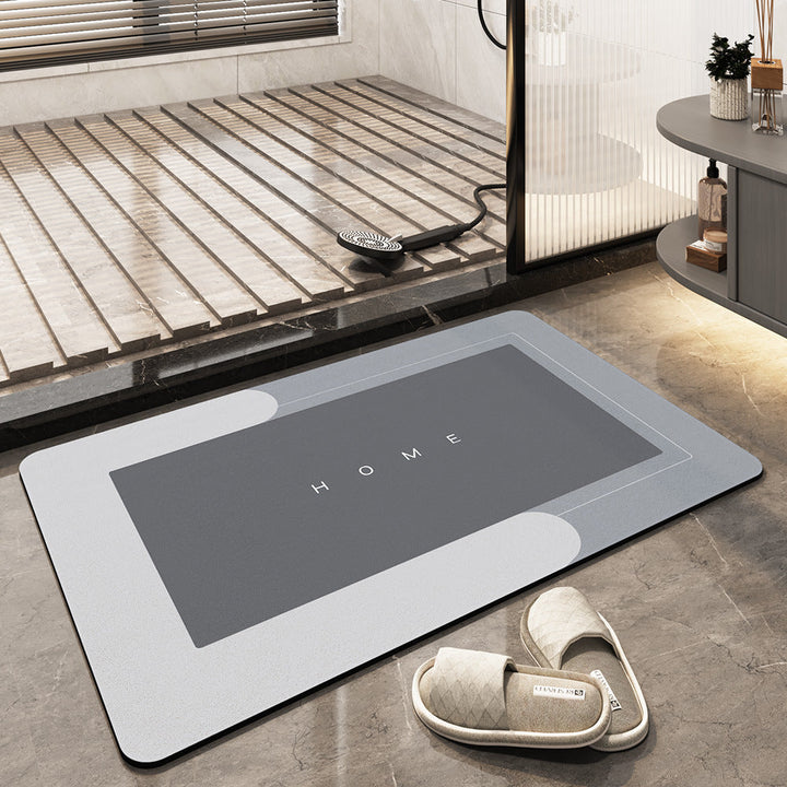 Tappeto da bagno antiscivolo grigio con scritta "HOME", design moderno, adatto per doccia, pavimento in marmo, include pantofole beige.