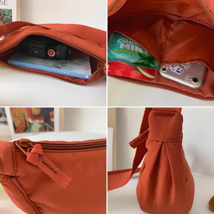 Borsa a tracolla arancione con cerniera, tasche interne, contenente fotocamera, libro e caramelle. Design moderno, ideale per viaggi e uso quotidiano.