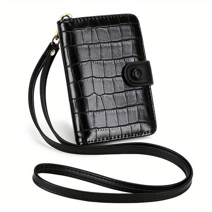 Portafoglio donna nero in pelle con stampa coccodrillo, chiusura a bottone, cinturino da polso, elegante e compatto. Accessorio moda femminile.