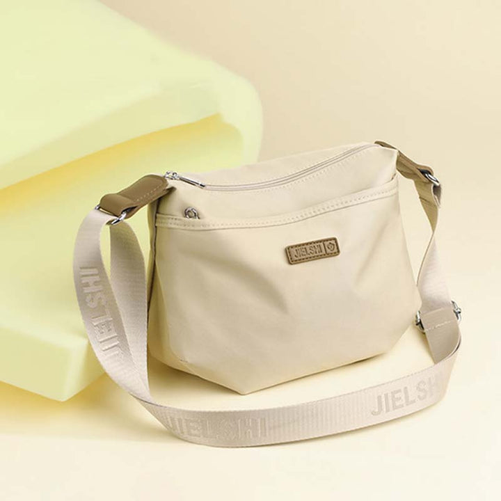 Borsa a tracolla beige Jielshi, design minimalista, con cerniera e cinturino regolabile. Accessorio moda donna, elegante e pratico.