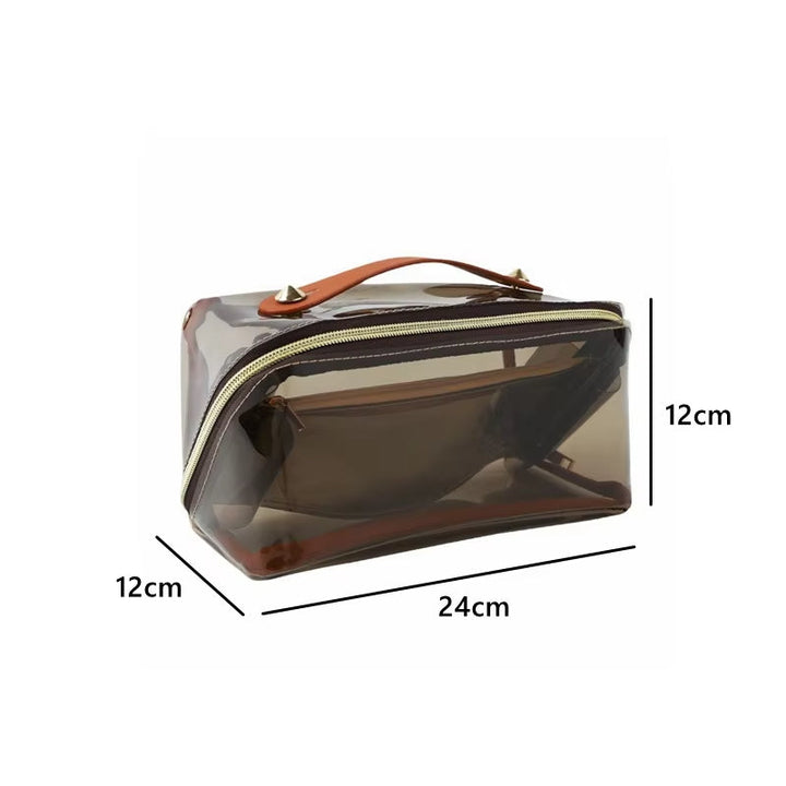 Borsa trasparente in PVC marrone con manico in pelle, chiusura a zip, dimensioni 24x12x12 cm. Ideale per cosmetici e accessori da viaggio.