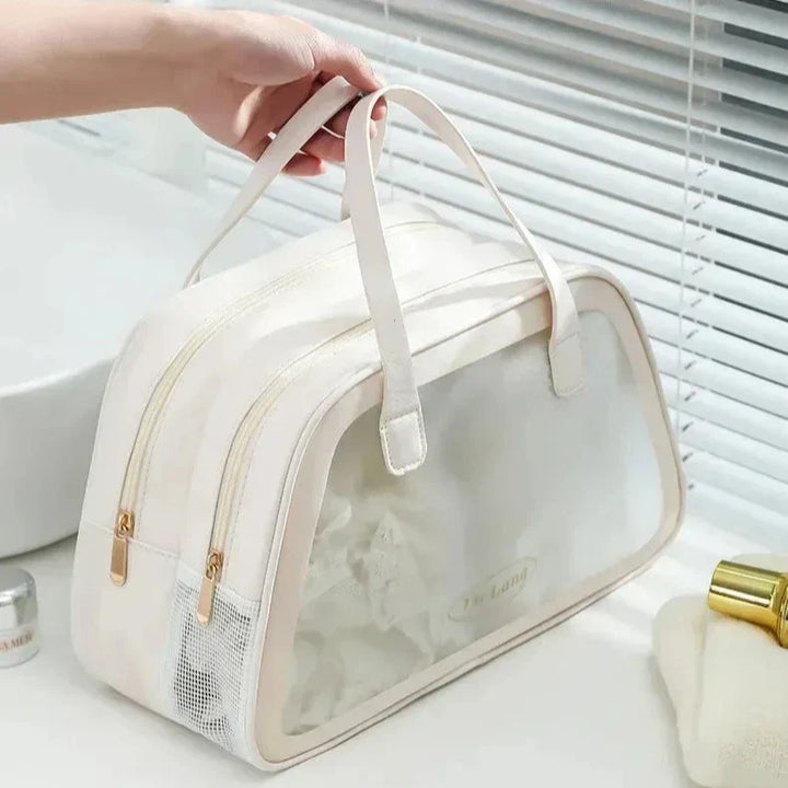 Borsa da viaggio bianca con doppia cerniera, tasca in rete e manici, ideale per organizzare articoli da toeletta. Design elegante e funzionale.