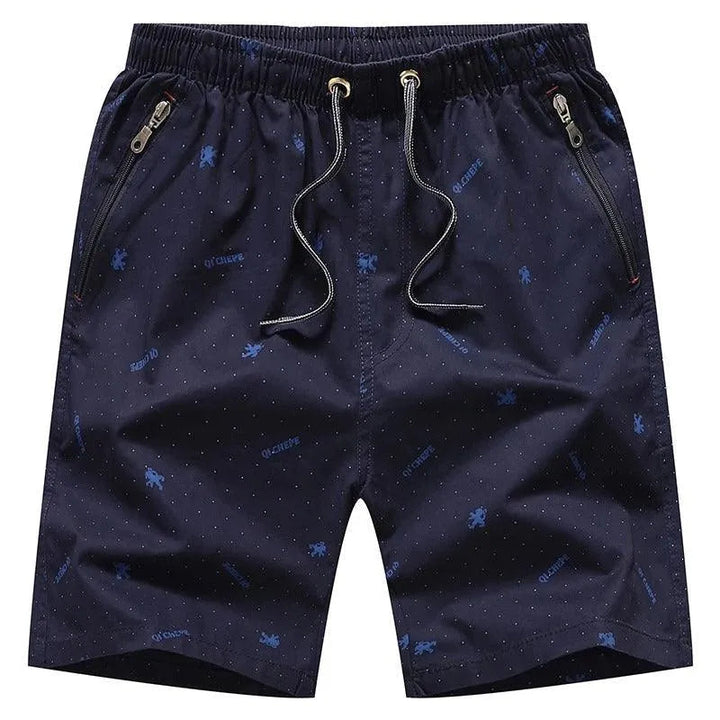 Pantaloncini uomo blu scuro con tasche con zip, motivo a pois e coulisse. Ideali per sport e tempo libero. Tessuto leggero e traspirante.