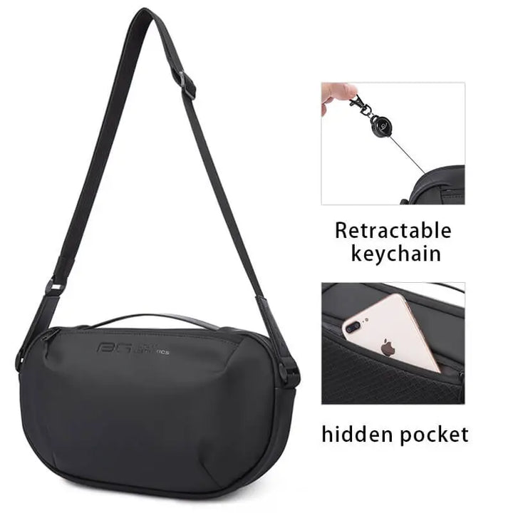 Borsa a tracolla nera con portachiavi retrattile e tasca nascosta, design moderno e funzionale, ideale per viaggi e uso quotidiano.
