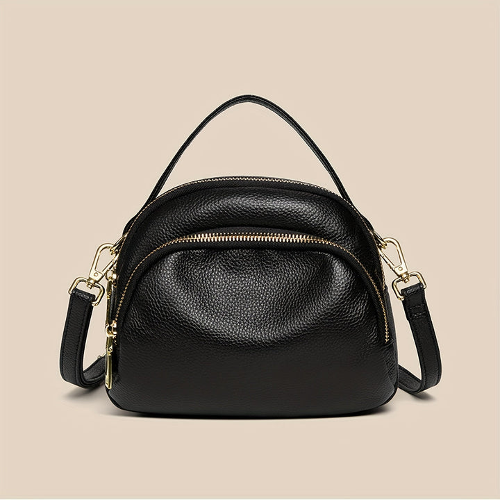 Borsa a tracolla in pelle nera con doppia zip e dettagli dorati, design elegante e compatto, perfetta per moda donna e accessori di lusso.