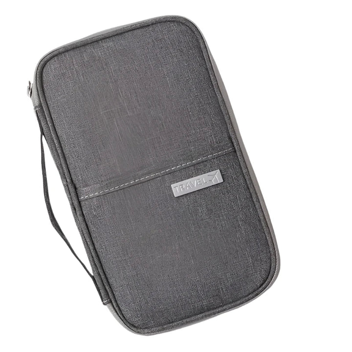 Custodia da viaggio grigia in tessuto, con cerniera e manico laterale. Ideale per organizzare accessori elettronici e documenti.