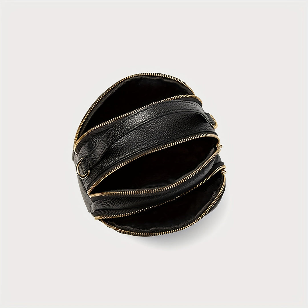 Borsa a tracolla nera in pelle con cerniere dorate, design moderno e unico, accessorio moda elegante per donna, perfetta per ogni occasione.