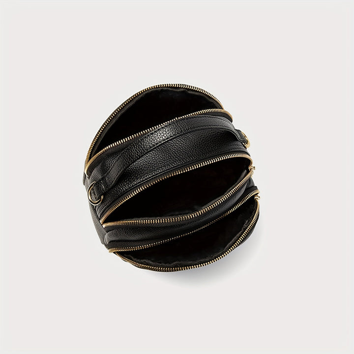Borsa a tracolla nera in pelle con cerniere dorate, design moderno e unico, accessorio moda elegante per donna, perfetta per ogni occasione.
