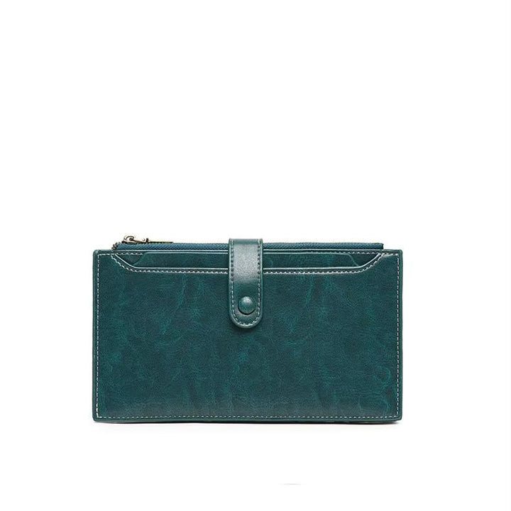 Portafoglio donna in pelle verde con chiusura a bottone, design elegante e compatto, ideale per carte e contanti. Accessorio moda femminile.