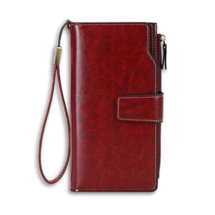 Portafoglio donna in pelle rossa con cinturino, chiusura a bottone, design elegante, ideale per carte e contanti. Accessorio moda di alta qualità.