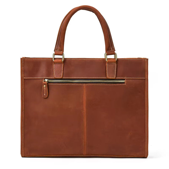 Borsa tote in pelle marrone con manici robusti e tasca frontale con cerniera. Elegante e spaziosa, ideale per lavoro e uso quotidiano.