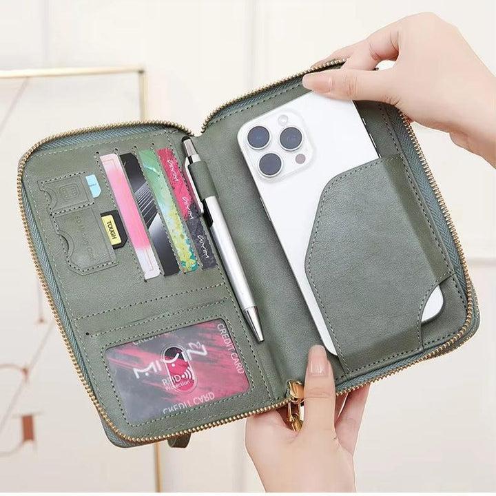 Portafoglio verde in pelle con cerniera, tasche per carte di credito, penna e scomparto per smartphone. Accessorio elegante e funzionale per l'organizzazione.