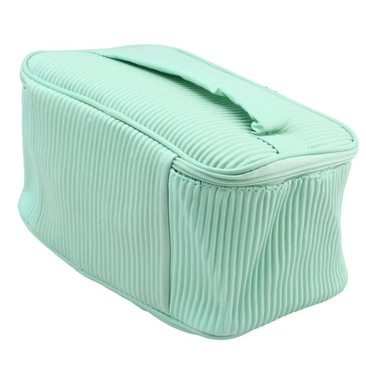 Borsa cosmetica verde menta, design a coste, con manico superiore e chiusura a zip. Ideale per organizzare trucchi e accessori da viaggio.