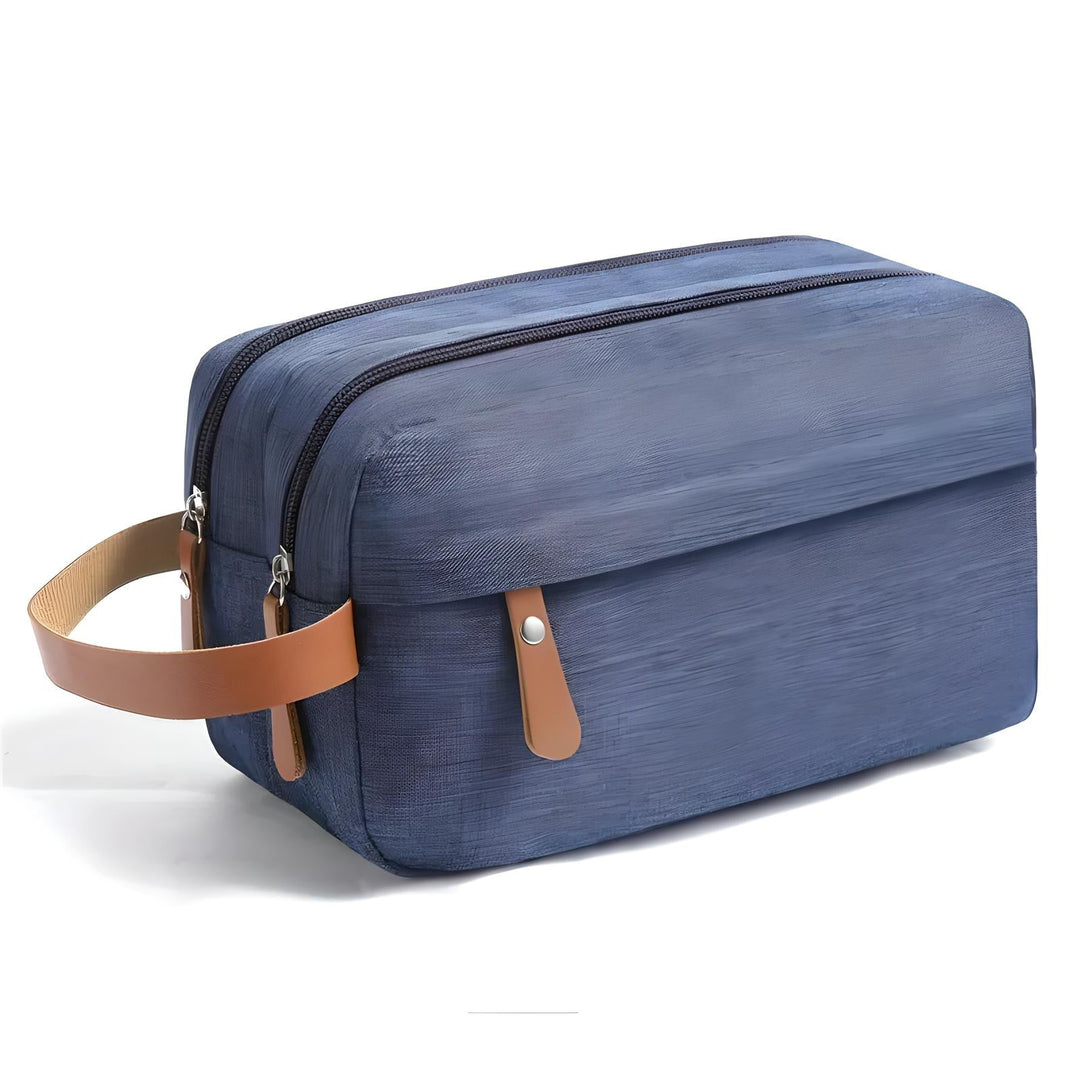 Borsello da viaggio blu in tessuto, doppia cerniera, manico in pelle marrone, ideale per organizzare articoli da toeletta.