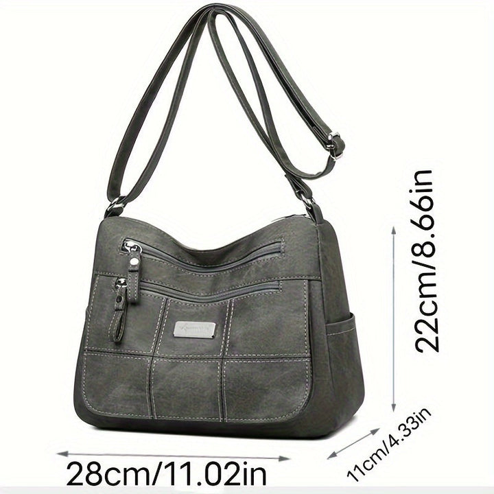 Borsa a tracolla in pelle grigia, dimensioni 28x22x11 cm, con tasche multiple e cerniere, design elegante e pratico per uso quotidiano.