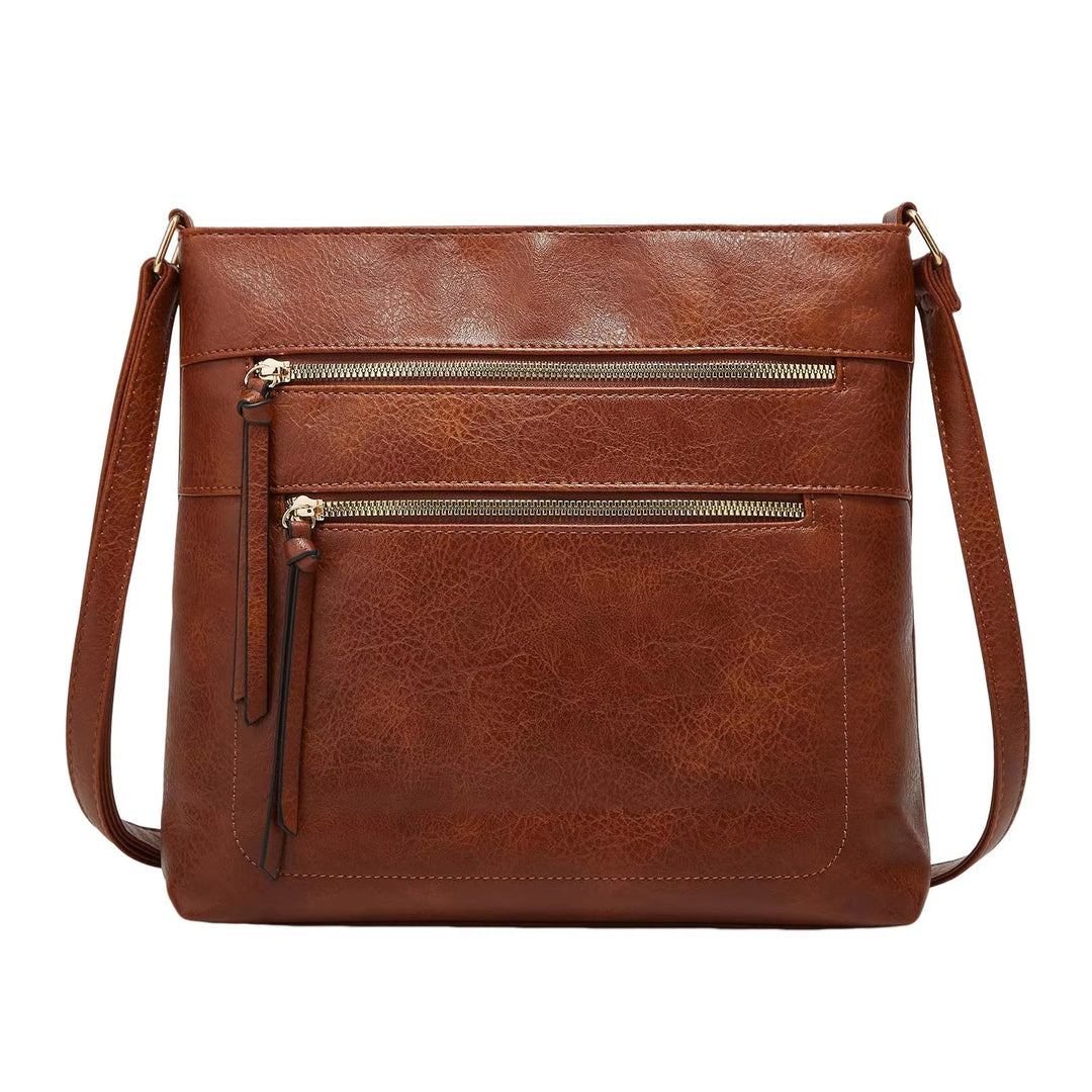 Borsa a tracolla in pelle marrone con doppie tasche frontali con cerniera, design elegante e pratico, ideale per moda donna e accessori quotidiani.