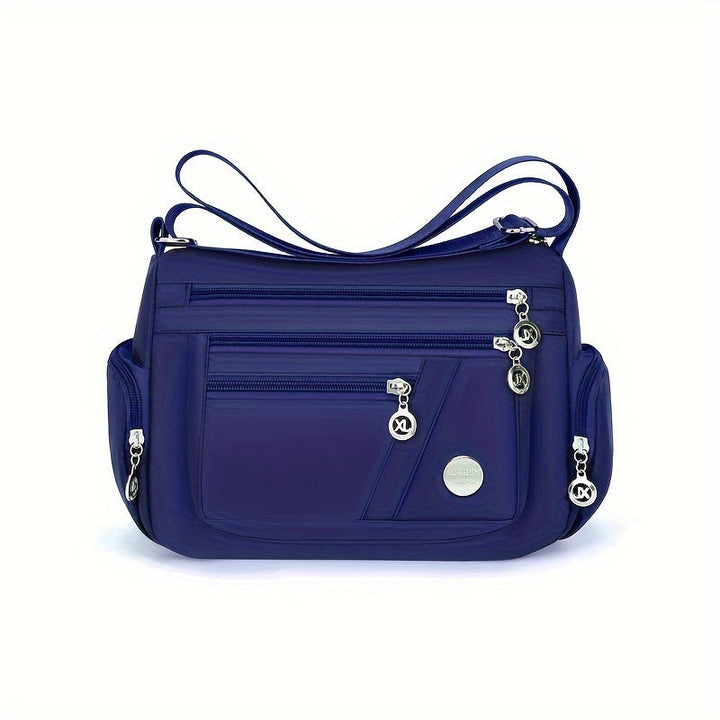 Borsa a tracolla blu in nylon con tasche multiple e cerniere, design elegante e funzionale, ideale per donna, accessorio moda versatile.