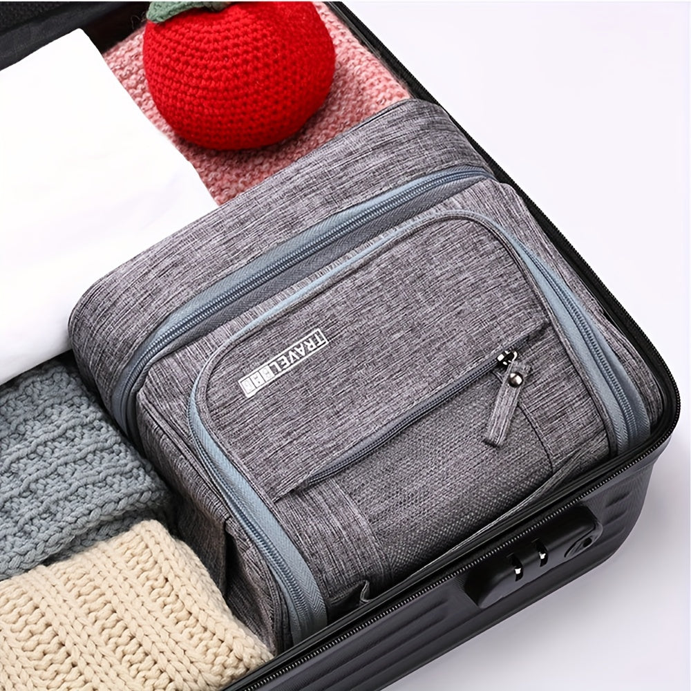Valigia aperta con organizer da viaggio grigio, tessuto resistente, zip doppia, ideale per abbigliamento, accessori, bagaglio a mano ordinato.