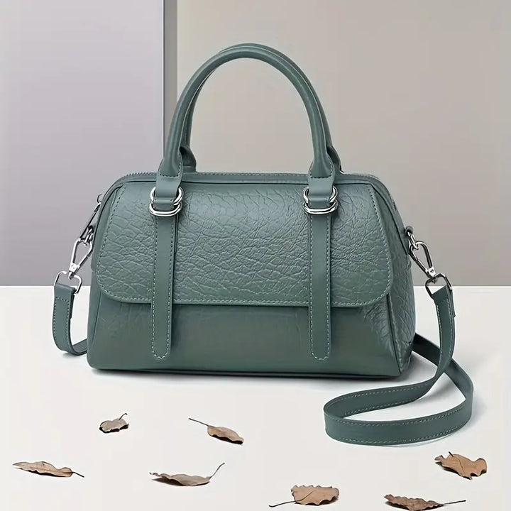 Borsa a mano in pelle verde, design elegante con tracolla removibile, ideale per moda donna. Accessorio chic per ogni occasione.