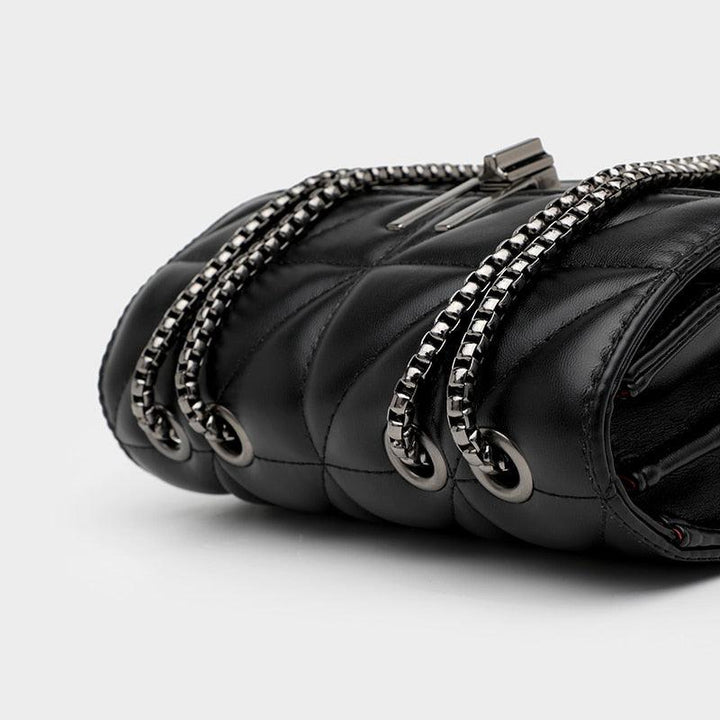 Borsa a tracolla in pelle nera trapuntata con catena metallica argentata, design elegante e moderno, accessorio moda donna di lusso.