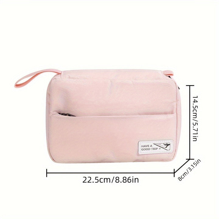 Borsa da viaggio rosa con tasca frontale, cerniera, manico laterale. Dimensioni: 22,5x14,5x8 cm. Ideale per cosmetici e accessori.