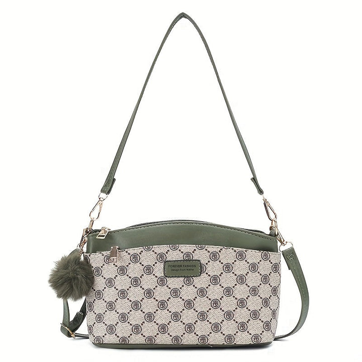 Borsa a tracolla donna in pelle verde e tessuto stampato, design elegante con pompon decorativo, ideale per moda casual e shopping.