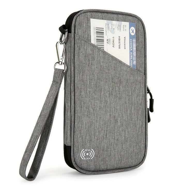 Custodia da viaggio grigia con cinturino, tasca esterna per biglietto aereo, chiusura zip, protezione RFID. Ideale per documenti e passaporto.