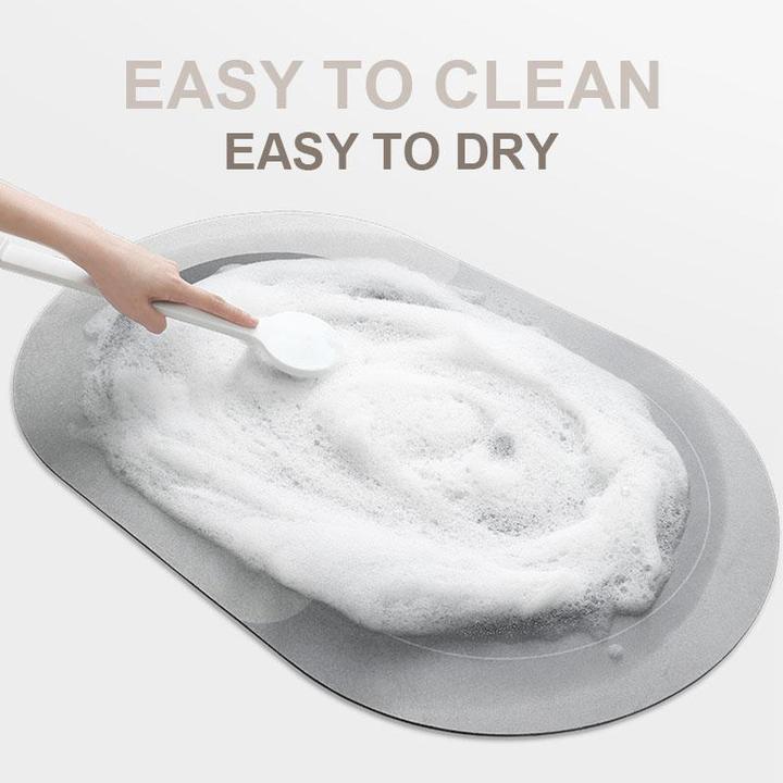 Tappetino da bagno antiscivolo grigio, facile da pulire e asciugare, con schiuma e mano che utilizza un cucchiaio. Ideale per sicurezza doccia.