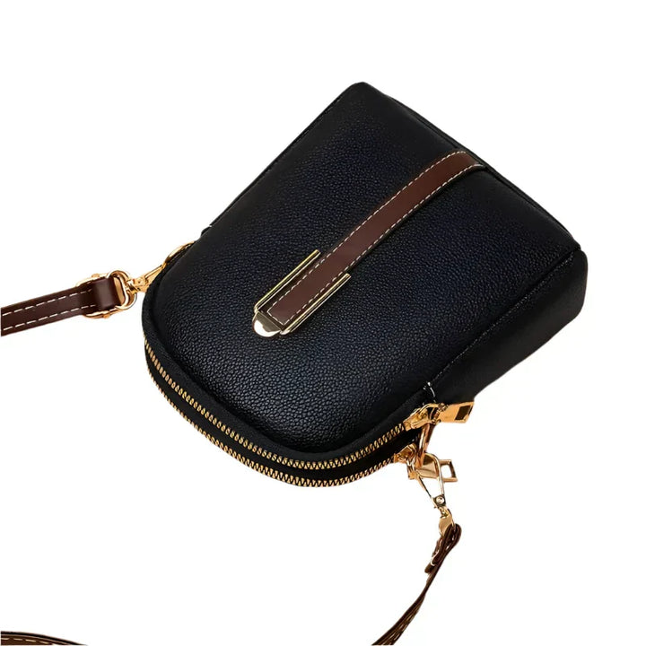 Borsa a tracolla in pelle nera con dettagli dorati e cinturino marrone, design elegante e compatto, ideale per moda femminile e accessori di lusso.