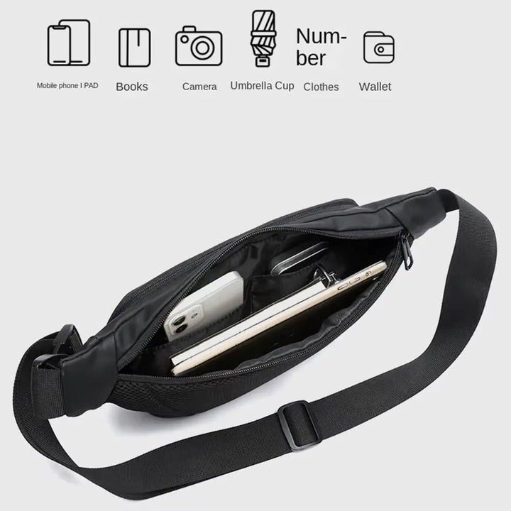 Marsupio nero aperto con scomparti, contenente smartphone, libro e tablet. Design moderno, ideale per viaggi e uso quotidiano. Tasche multiple.