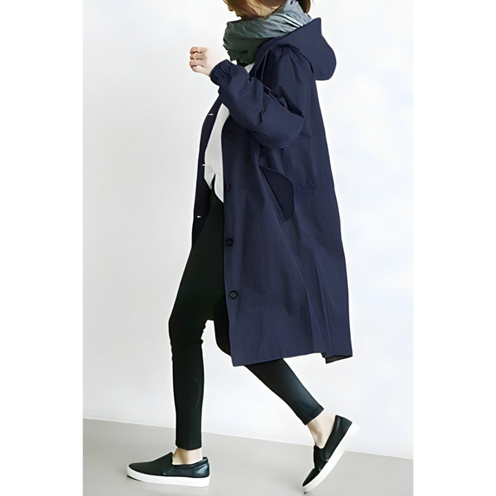 Donna con cappotto blu scuro, sciarpa grigia, leggings neri e scarpe da ginnastica nere. Moda autunnale casual, abbigliamento femminile elegante.