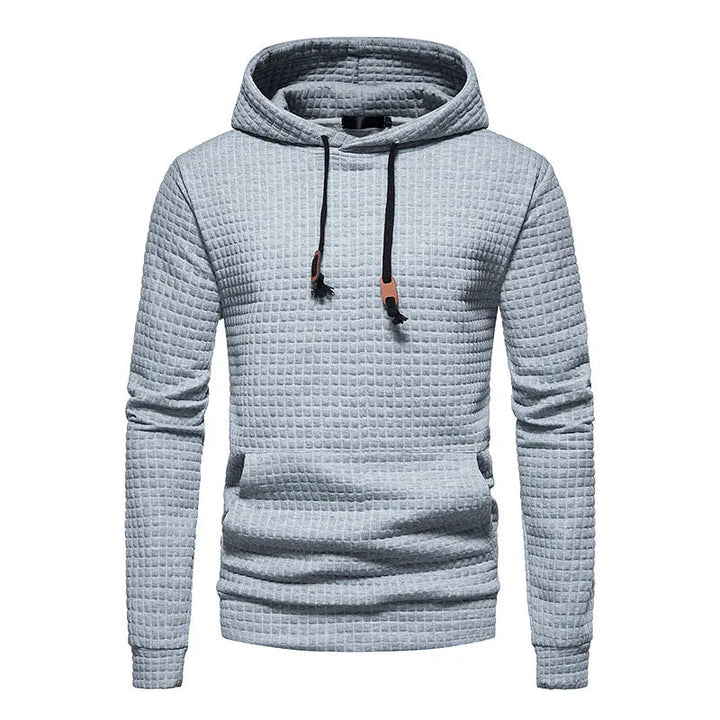 Felpa con cappuccio grigia a trama quadrettata, design casual, cordini regolabili, ideale per moda uomo autunno inverno.
