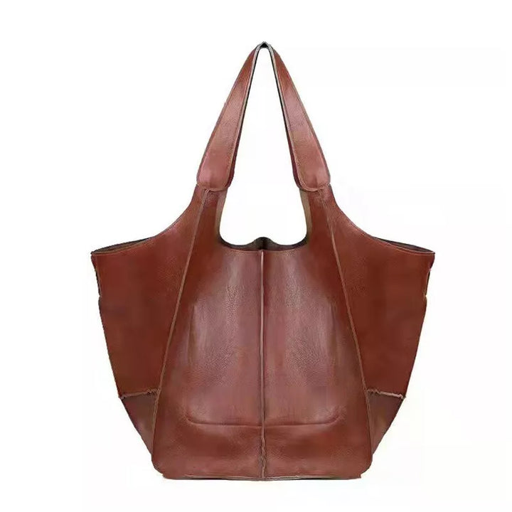 Borsa shopper in pelle marrone, design elegante e spazioso, ideale per moda donna. Accessorio versatile per shopping e uso quotidiano.