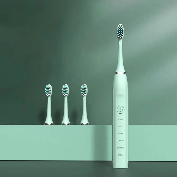 Spazzolino elettrico verde con tre testine di ricambio, design moderno, setole multicolore, ideale per igiene orale avanzata e cura dentale.