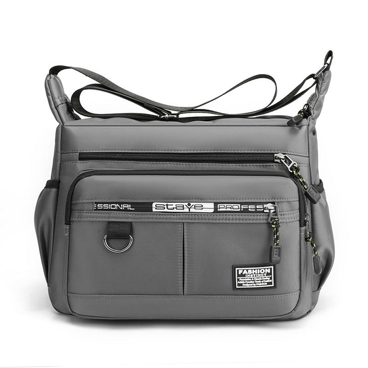 Borsa a tracolla grigia unisex, design moderno, tasche multiple con zip, ideale per viaggio e lavoro. Materiale resistente e impermeabile.