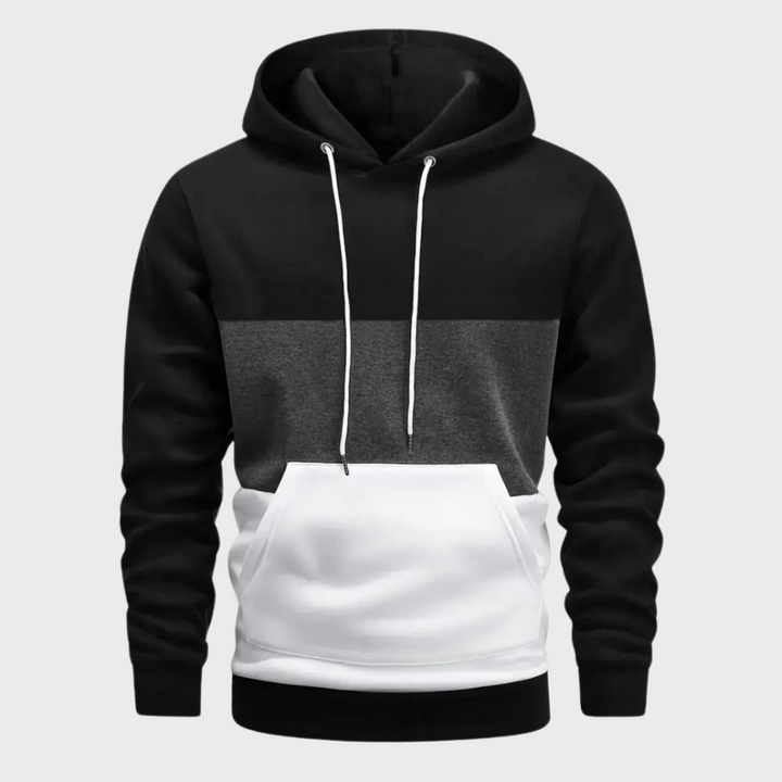 Felpa con cappuccio uomo, design a blocchi di colore nero, grigio e bianco, tasca frontale, cordini bianchi. Moda casual, abbigliamento autunnale.