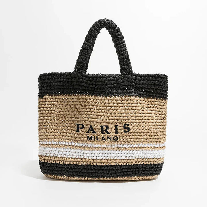 Borsa in paglia intrecciata beige e nera con manici, scritta "Paris Milano", design elegante, perfetta per l'estate e lo shopping.
