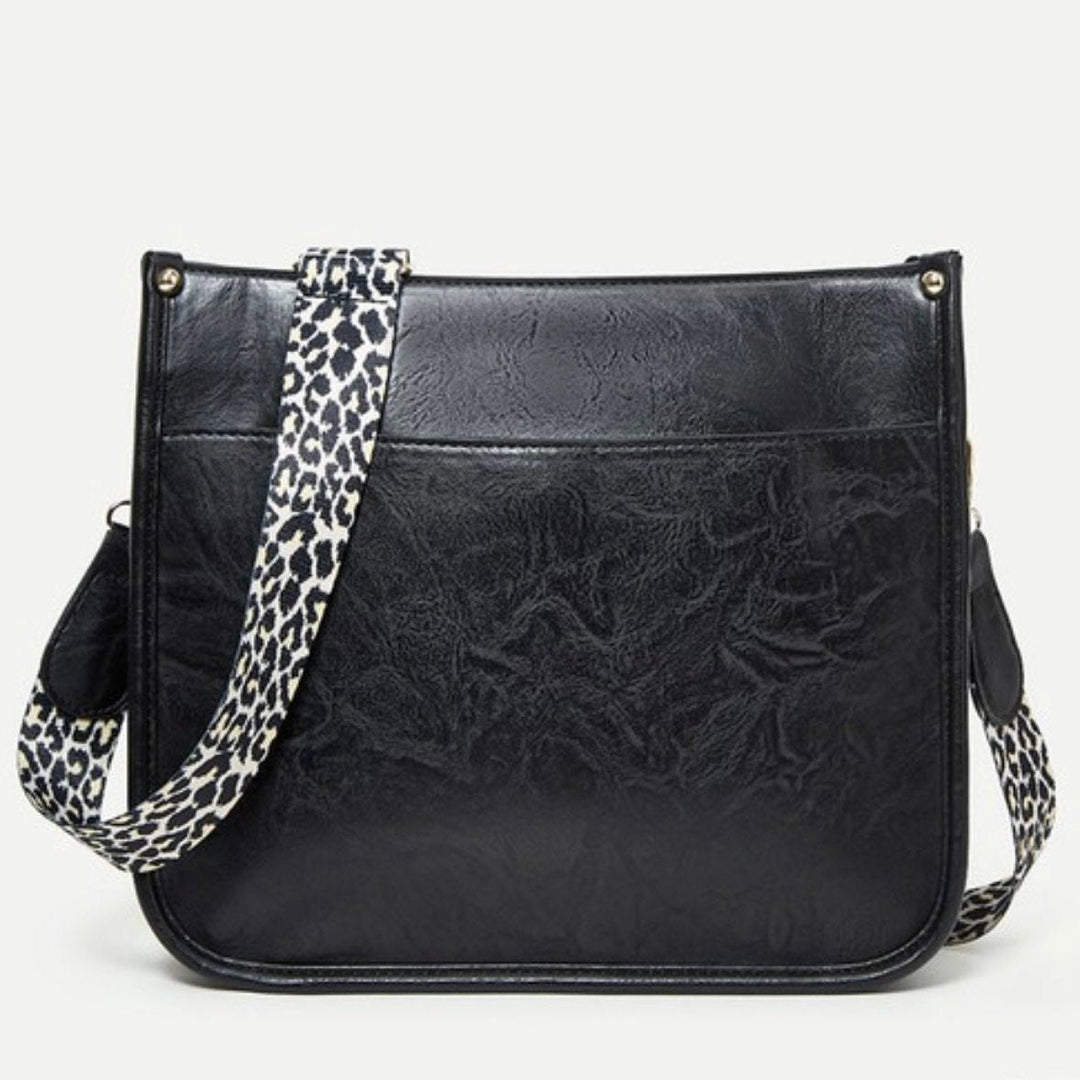 Borsa a tracolla in pelle nera con cinturino leopardato, design elegante e moderno, accessorio moda donna, perfetta per ogni occasione.