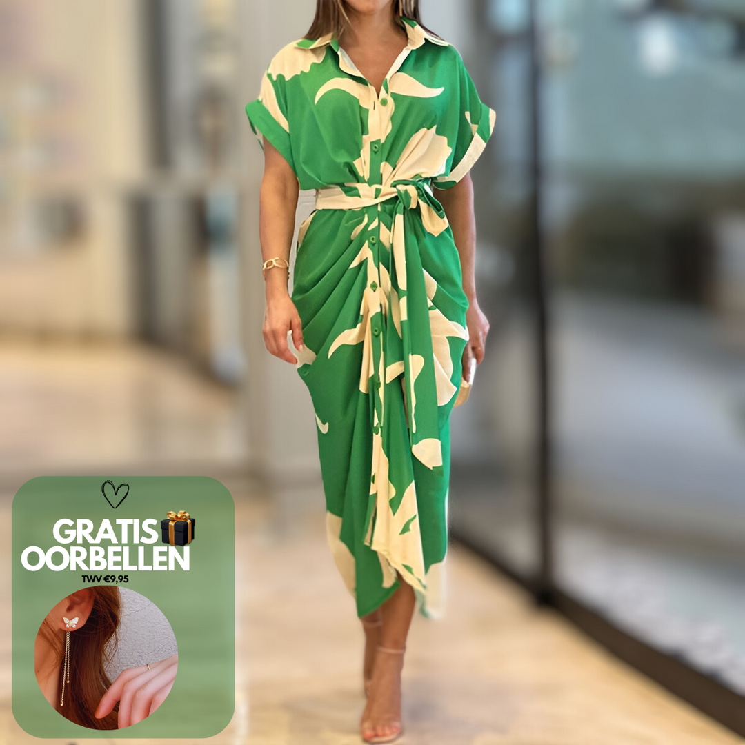 Abito lungo verde con motivo bianco, maniche corte e cintura in vita. Donna in sandali trasparenti. Offerta: orecchini gratis. Moda elegante.