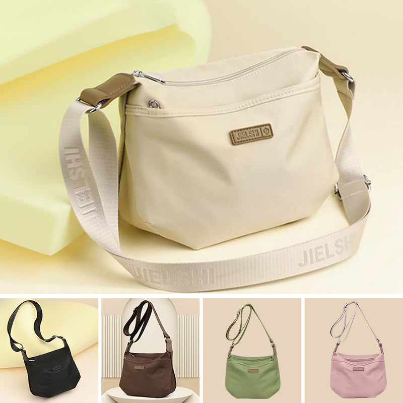 Borsa a tracolla beige con cerniera, marchio Jielsh, tracolla regolabile. Disponibile in nero, marrone, verde, rosa. Design elegante e versatile.
