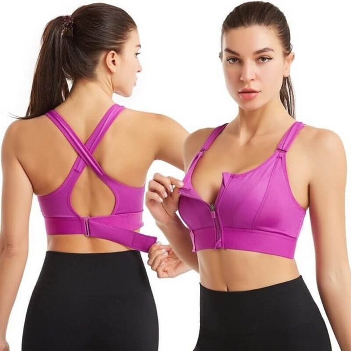 Due donne indossano reggiseni sportivi viola con cerniera frontale e spalline incrociate, ideali per fitness e yoga. Abbigliamento sportivo donna.