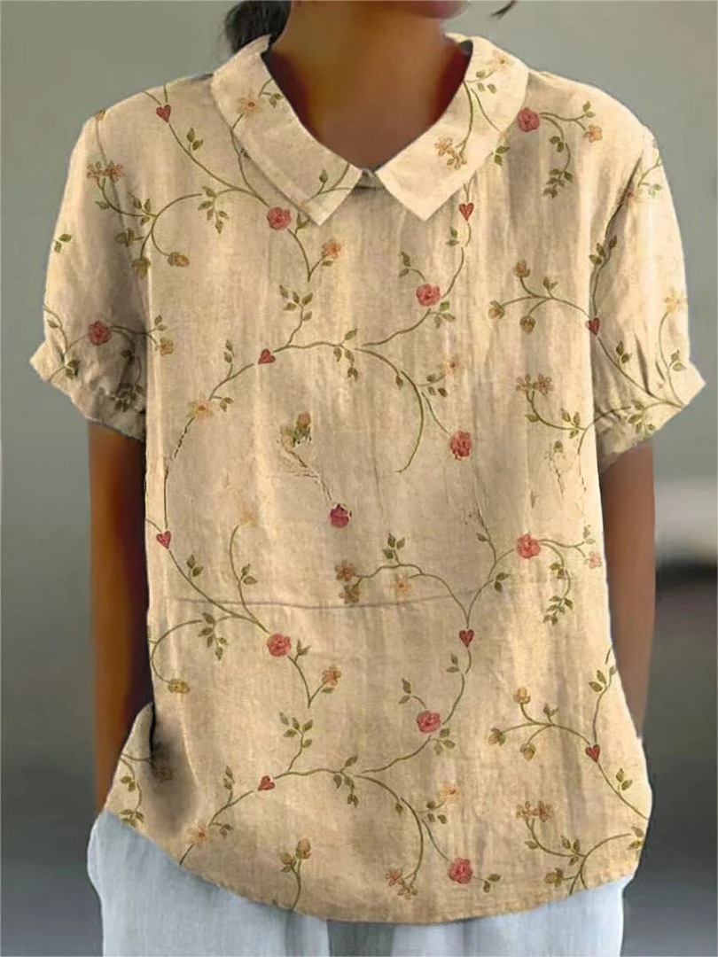 Camicia donna beige con colletto, maniche corte e stampa floreale vintage. Elegante e casual, ideale per moda estiva e primaverile.