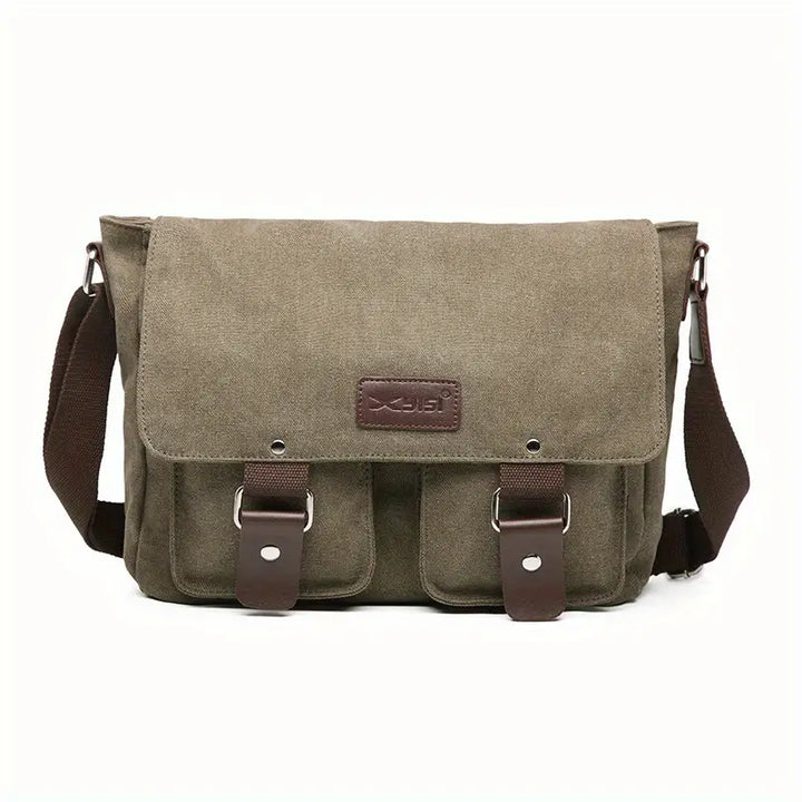 Borsa a tracolla in tela verde oliva con chiusure a fibbia marroni, tasche frontali e tracolla regolabile. Stile casual, ideale per uomo e donna.