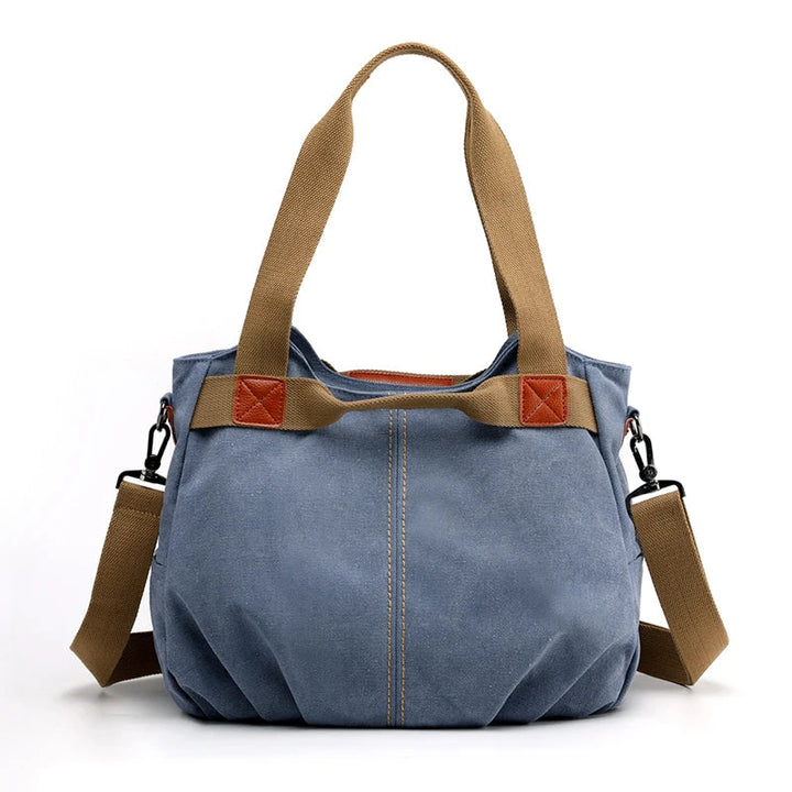Borsa a tracolla in tela blu con manici marroni, design casual, chiusura a zip, ideale per donna, moda quotidiana, resistente e spaziosa.