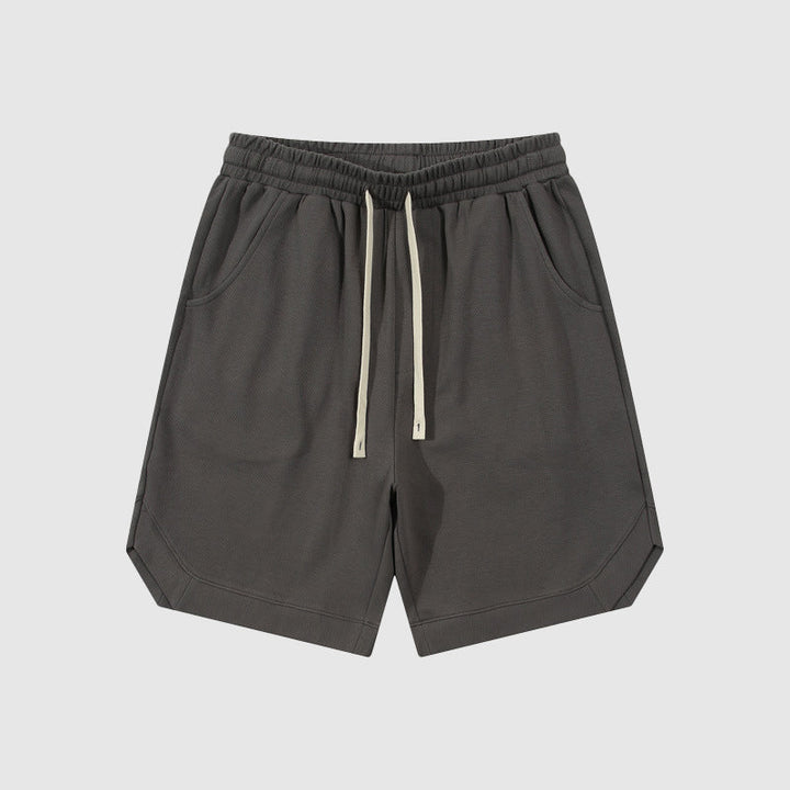 Pantaloncini sportivi grigi da uomo, con elastico in vita e laccetti, tasche laterali, design casual. Ideali per palestra e tempo libero.