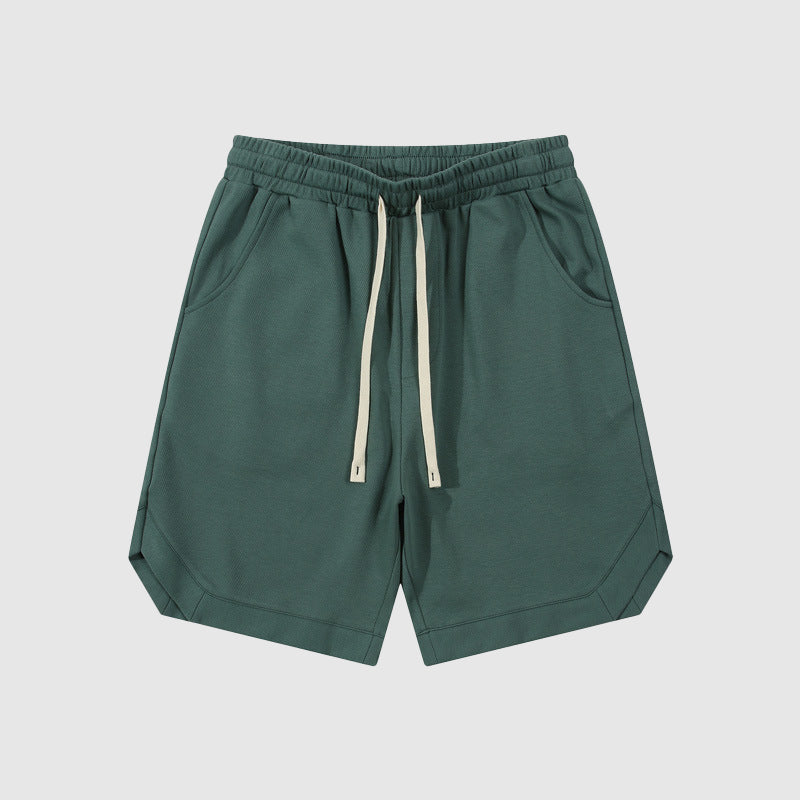Pantaloncini sportivi verde scuro da uomo con coulisse, tasche laterali, orlo dritto. Ideali per attività sportive e tempo libero.