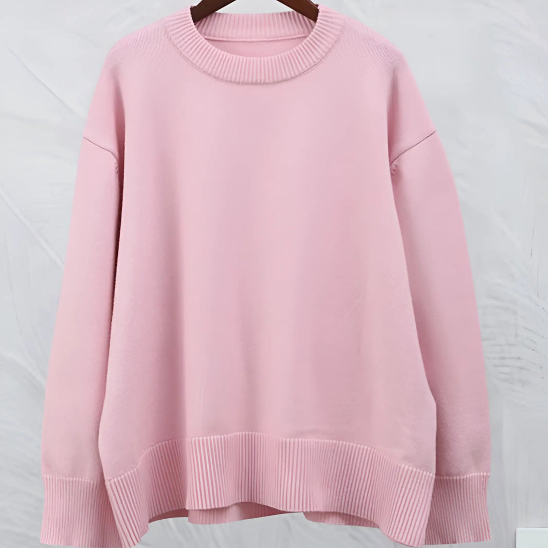 Maglione oversize rosa pastello in cotone, design minimalista, maniche lunghe, scollo rotondo, ideale per moda casual e abbigliamento autunnale.