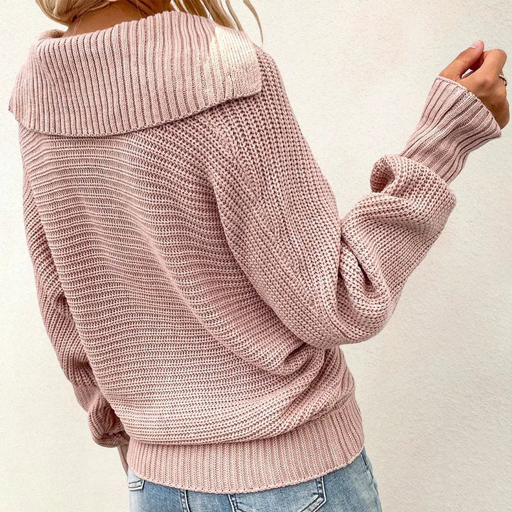 Maglione donna rosa a maglia grossa con collo alto, maniche lunghe, indossato con jeans chiari. Stile casual, moda autunno inverno.