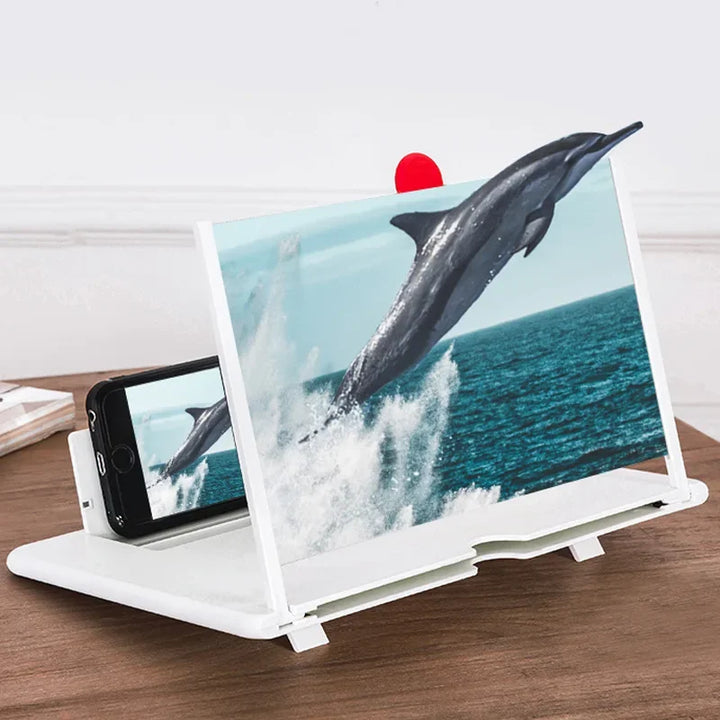 Amplificatore schermo smartphone bianco su tavolo in legno, ingrandisce immagine di delfino che salta dall'acqua. Accessorio pratico per visione video.